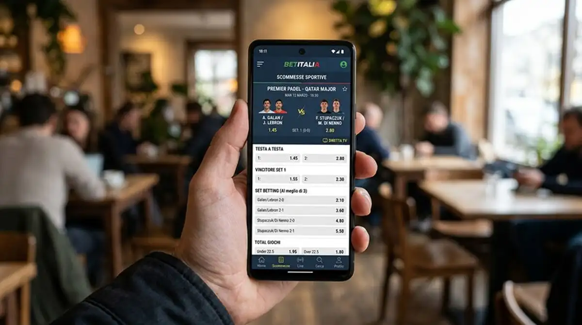 Smartphone in mano con app mobile di un bookmaker ADM che mostra il palinsesto live di un torneo Premier Padel